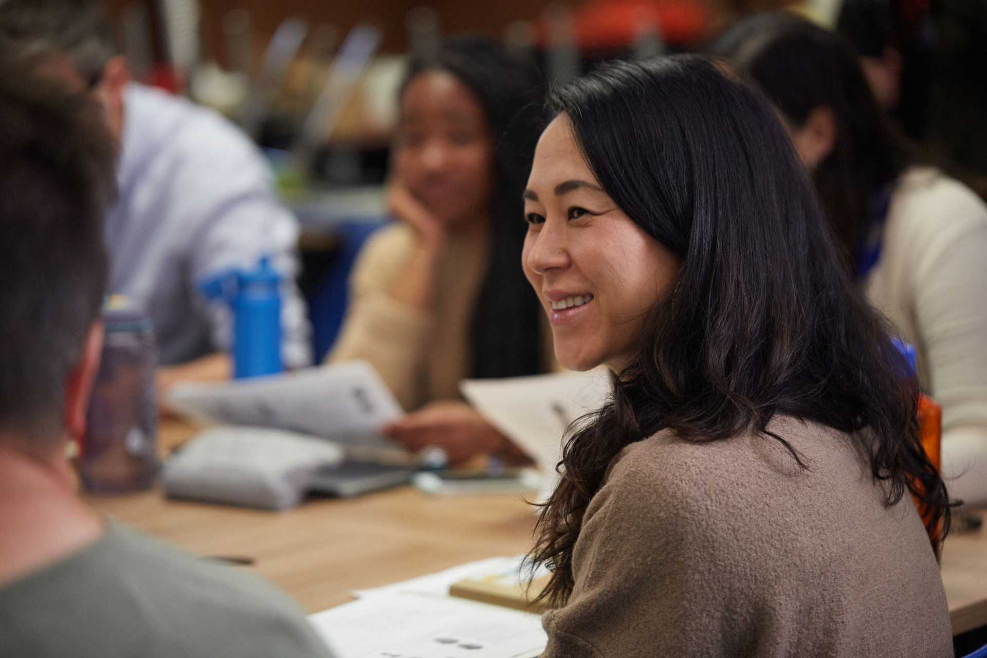 A small group of students gathered at a table