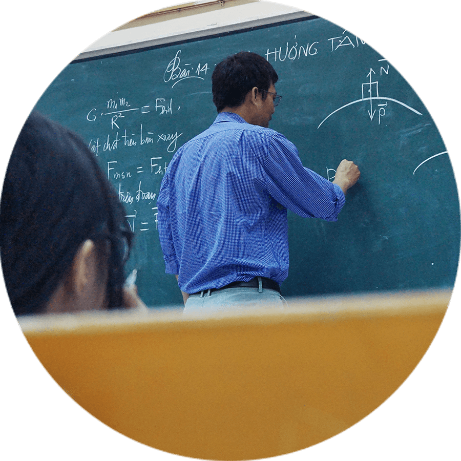 a teacher writing on a chalk board