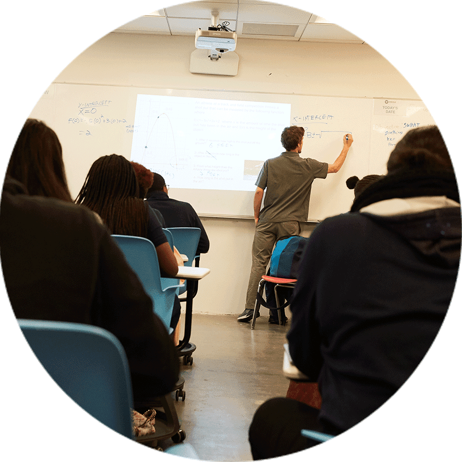 a teacher writing on a white board