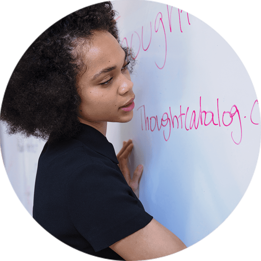 a sutdent writing on a white board