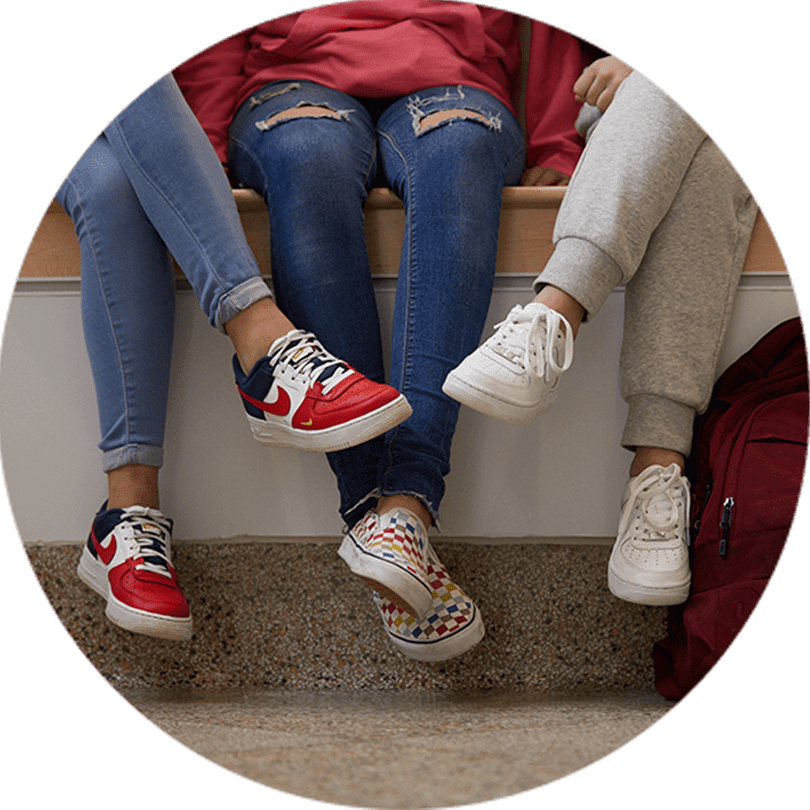 students sitting wearing sneakers