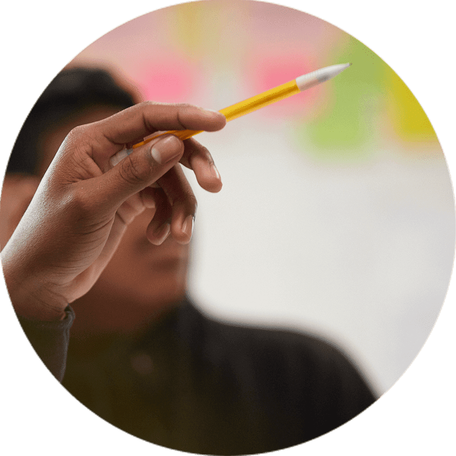 a person holding a pencil pointing