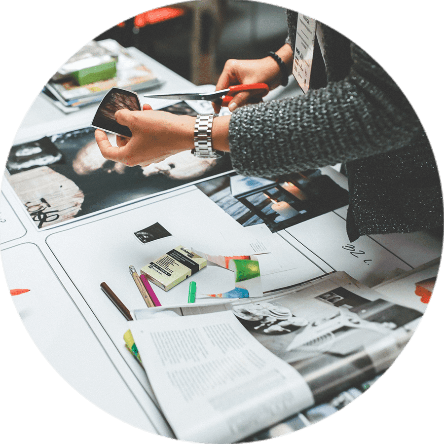 a person trimming photographs