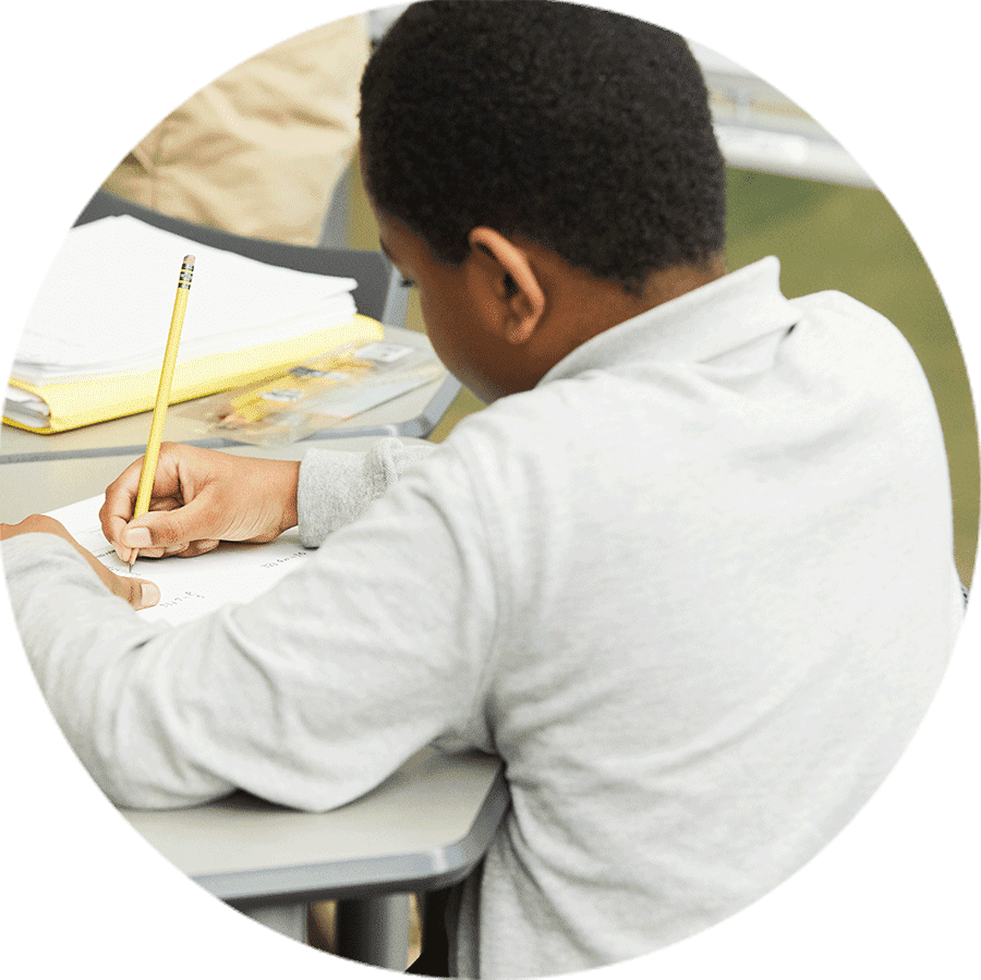 student writing with a pencil